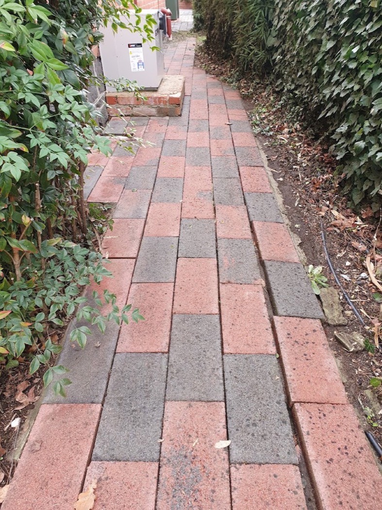 A brick paved path in Ballarat washed back to a clean red