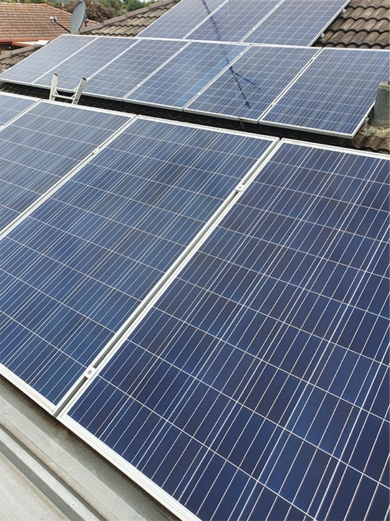 Roof mounted solar panels washed clean of dust and grime