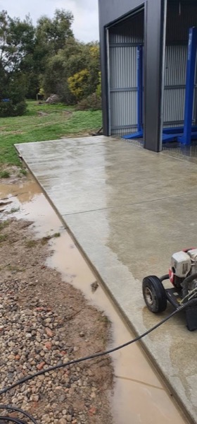 A wet concrete driveway freshly washed down