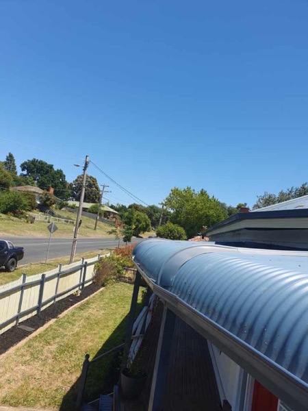 A corrugated verandah roof cleaned along a Ballarat street